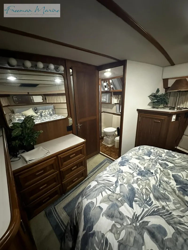 Slide: The Image of 1988 Carver 4207 Aft Cabin interior with bed, dresser, and bathroom. - 24