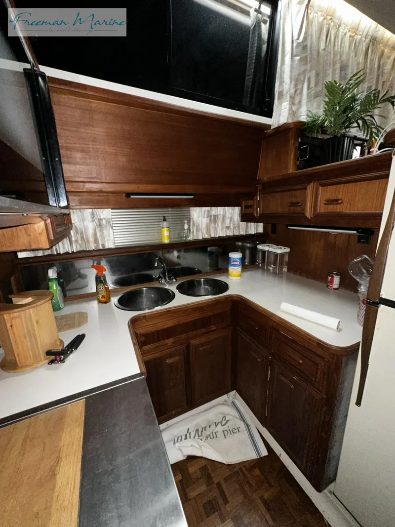 Slide: The Image of 1988 Carver 4207 Aft Cabin kitchen with wood cabinetry and modern appliances. - 26
