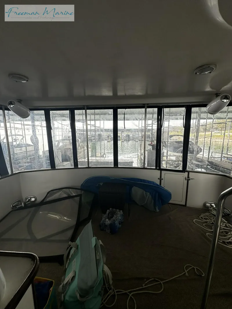 Slide: The Image of Interior view of 1988 Carver 4207 Aft Cabin with large windows and nautical equipment. - 30