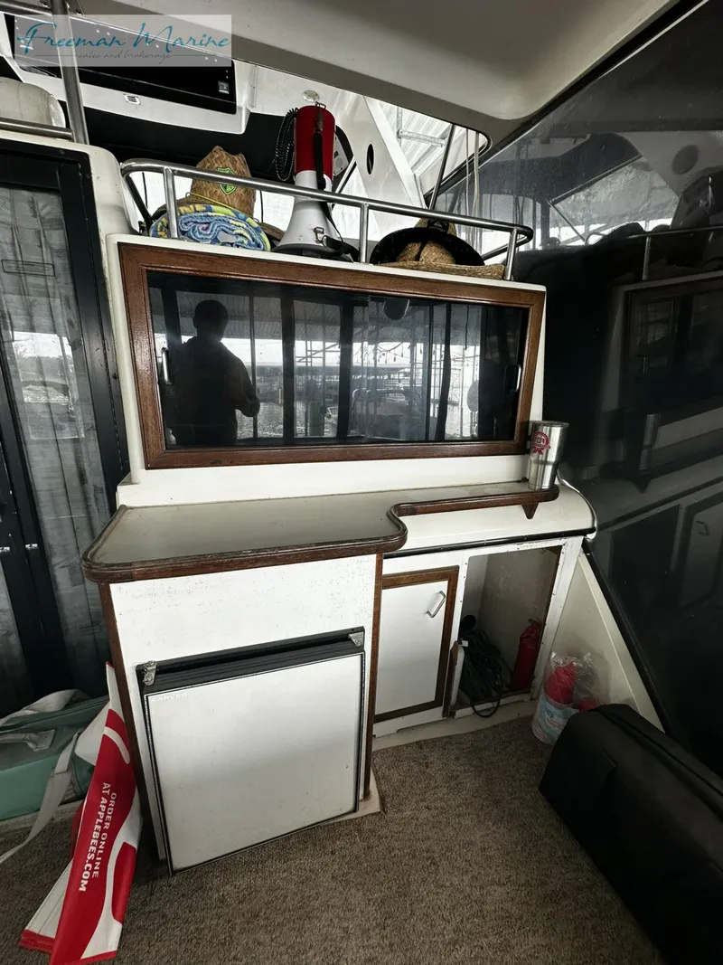 Slide: The Image of 1988 Carver 4207 Aft Cabin interior with storage and mini fridge. - 31