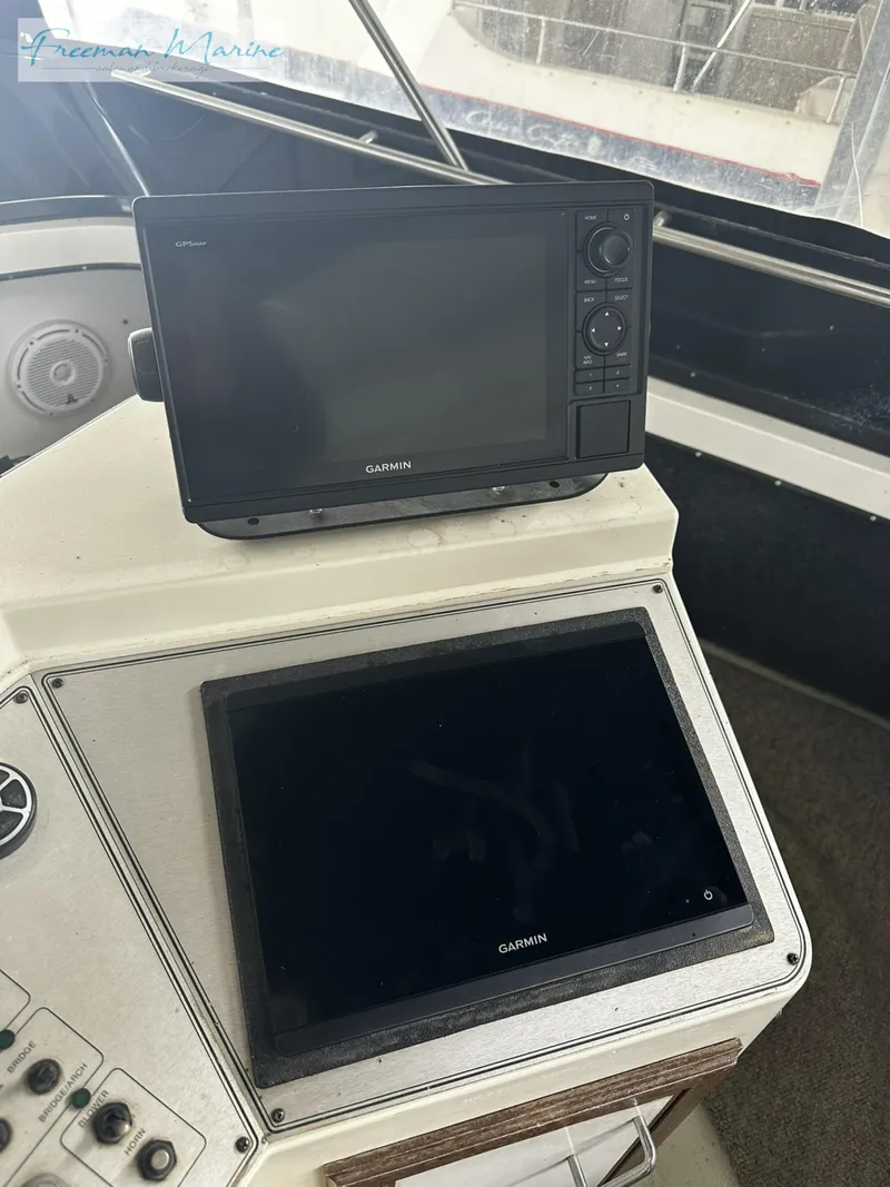 Slide: The Image of 1988 Carver 4207 Aft Cabin helm with Garmin navigation displays. - 33