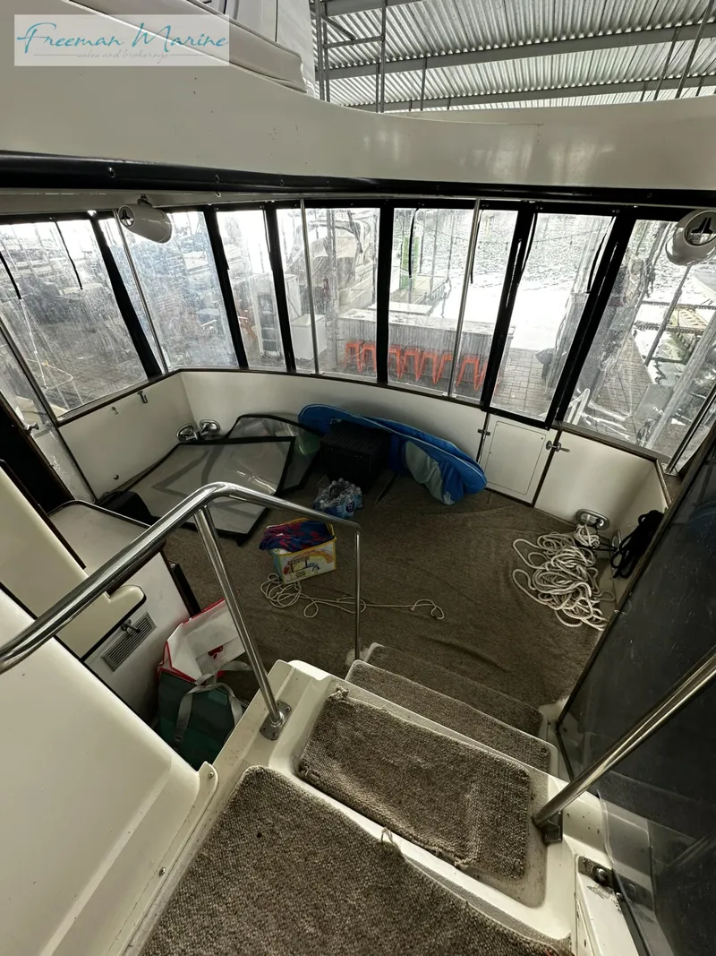 Slide: The Image of 1988 Carver 4207 Aft Cabin interior with carpeted stairs and panoramic windows. - 34