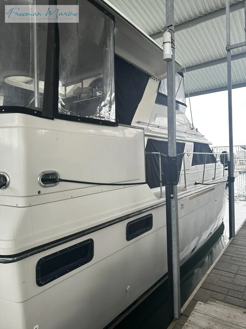 Slide: The Image of 1988 Carver 4207 Aft Cabin yacht docked under shelter. - 4
