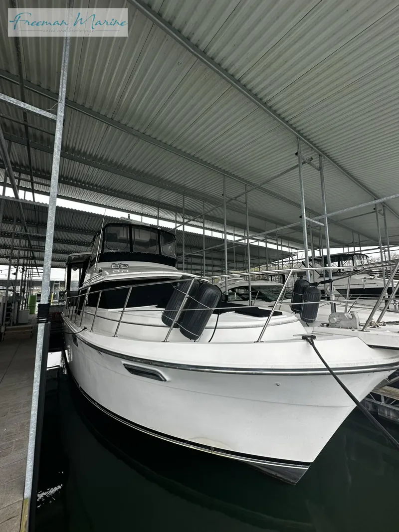 Slide: The Image of 1988 Carver 4207 Aft Cabin yacht docked in covered marina. - 5