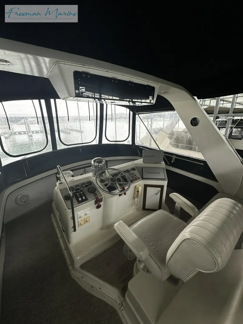 Slide: The Image of 1988 Carver 4207 Aft Cabin helm with steering wheel and controls. - 6