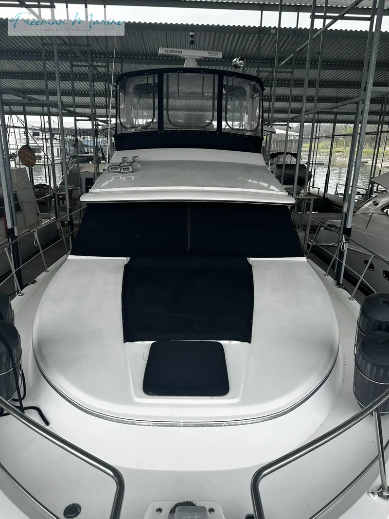 Slide: The Image of 1988 Carver 4207 Aft Cabin yacht docked in a covered marina. - 9