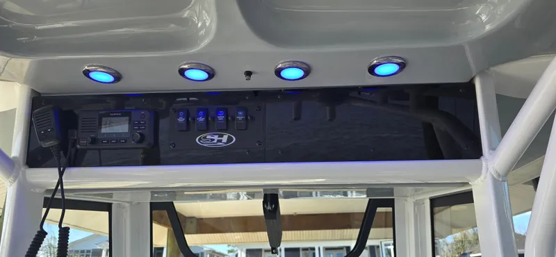 Slide: The Image of Control panel of 2023 Sea Hunt Escape 250 boat with blue LED lights. - 10
