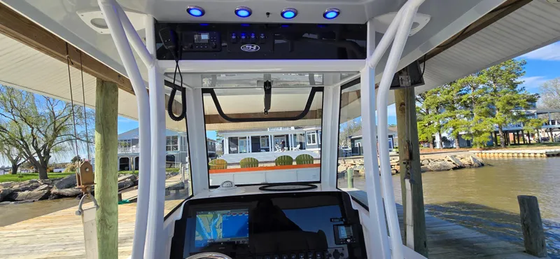 Slide: The Image of 2023 Sea Hunt Escape 250 boat at dock, featuring advanced navigation system. - 11