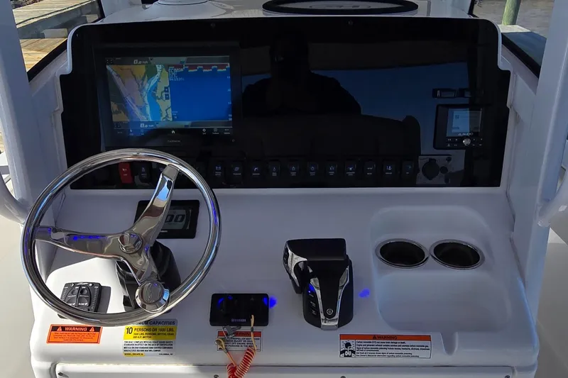 Slide: The Image of 2023 Sea Hunt Escape 250 boat dashboard with navigation system and controls. - 12