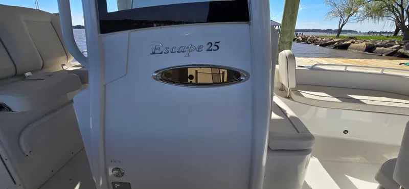 Slide: The Image of 2023 Sea Hunt Escape 250 boat interior with seating and water view. - 14