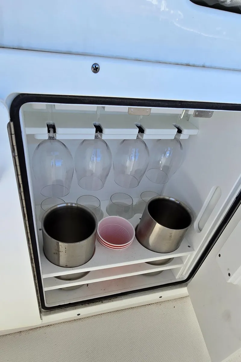 Slide: The Image of 2023 Sea Hunt Escape 250 boat with built-in storage for glasses and cups. - 16