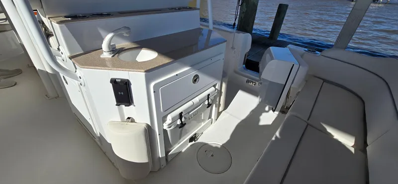 Slide: The Image of 2023 Sea Hunt Escape 250 boat interior with sink and seating area. - 17