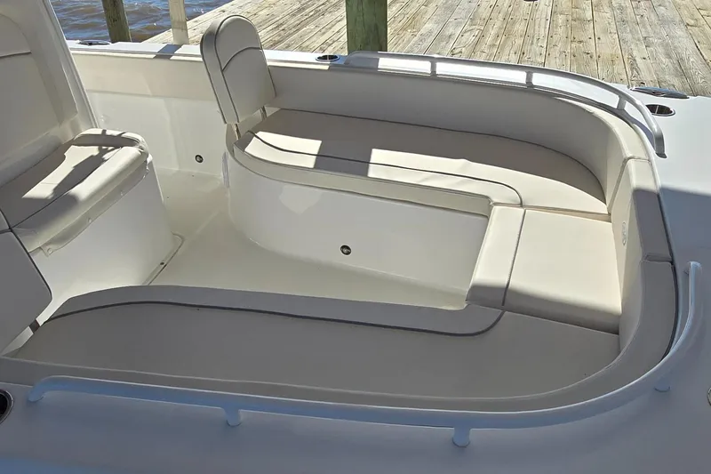 Slide: The Image of 2023 Sea Hunt Escape 250 boat seating area with cushioned benches and storage compartments. - 25