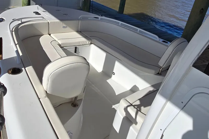 Slide: The Image of 2023 Sea Hunt Escape 250 boat interior with white seating and spacious layout. - 26