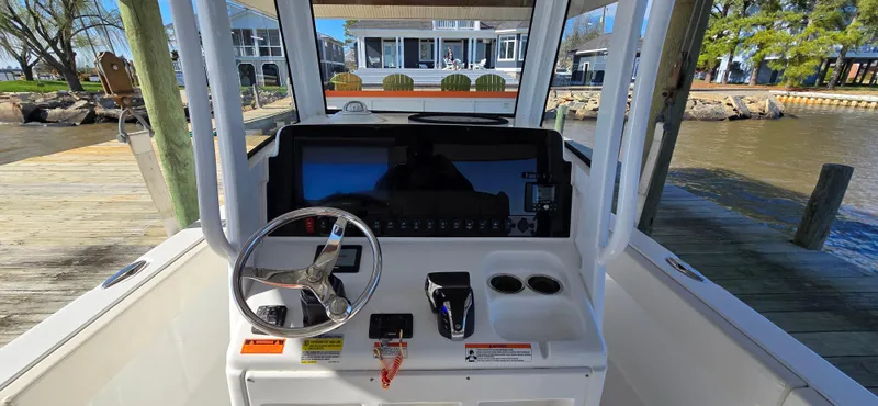 Slide: The Image of 2023 Sea Hunt Escape 250 boat console with steering wheel and controls. - 5