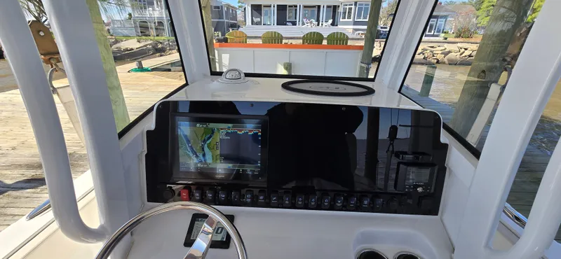 Slide: The Image of 2023 Sea Hunt Escape 250 boat dashboard with navigation system and steering wheel. - 6