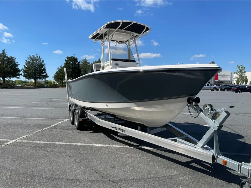 The Image of 2024 Mako 214 CC boat on trailer in parking lot under blue sky. - 0