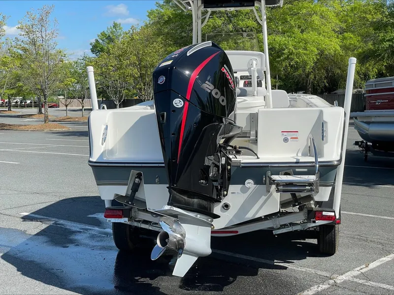 Slide: The Image of 2024 Mako 214 CC boat with powerful outboard motor in parking lot. - 3