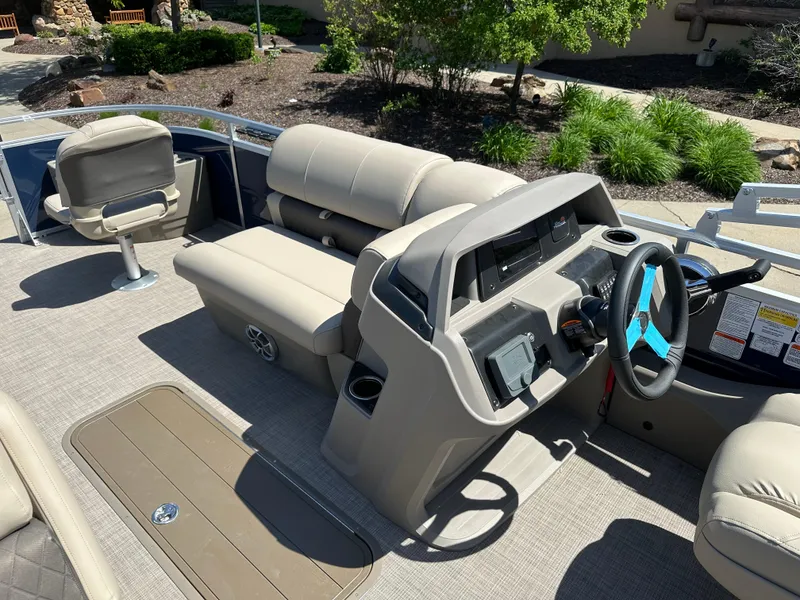 Slide: The Image of 2024 Sun Tracker Fishin' Barge 22 XP3 interior with helm, seating, and console. - 5