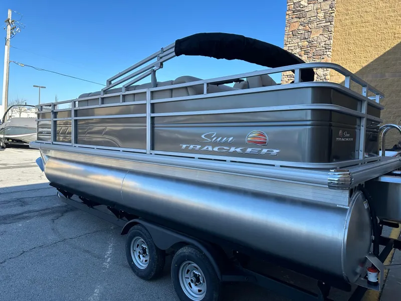 Slide: The Image of 2024 Sun Tracker Fishin' Barge 20 DLX pontoon boat on trailer. - 2
