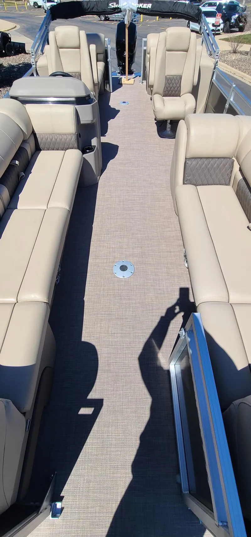 Slide: The Image of 2024 Sun Tracker Party Barge 24 DLX interior with beige seating and spacious layout. - 4