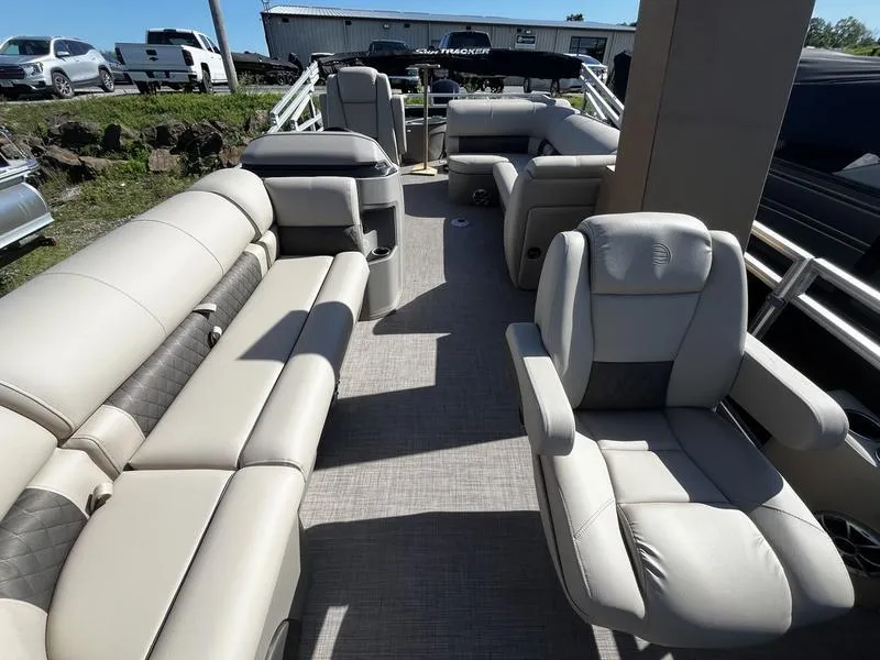 Slide: The Image of 2024 Sun Tracker SportFish 20 DLX pontoon boat interior with plush seating. - 6