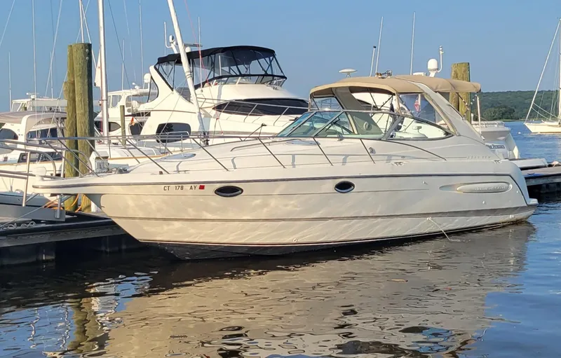 The Image of 2001 Maxum 3300 SCR yacht docked at marina, surrounded by other boats. - 0