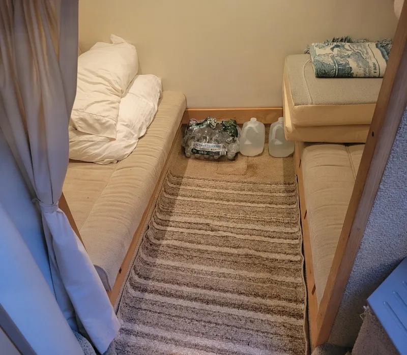 Slide: The Image of Cozy cabin interior of 2001 Maxum 3300 SCR with beige seating and striped carpet. - 10