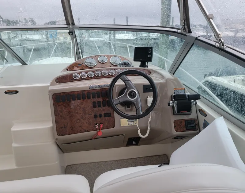 Slide: The Image of 2001 Maxum 3300 SCR boat helm with steering wheel and control panel. - 4