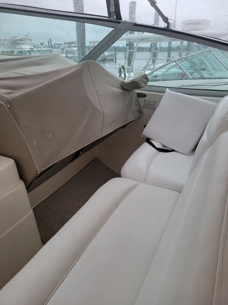 Slide: The Image of 2001 Maxum 3300 SCR boat interior with white seating and covered dashboard. - 5