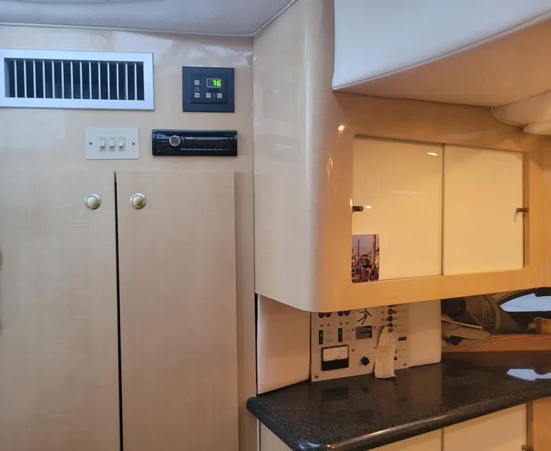 Slide: The Image of 2001 Maxum 3300 SCR yacht interior with cabinets, control panel, and countertop. - 7