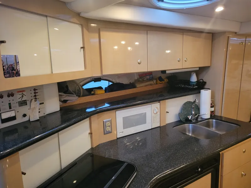 Slide: The Image of 2001 Maxum 3300 SCR yacht kitchen with modern appliances and sleek cabinetry. - 8