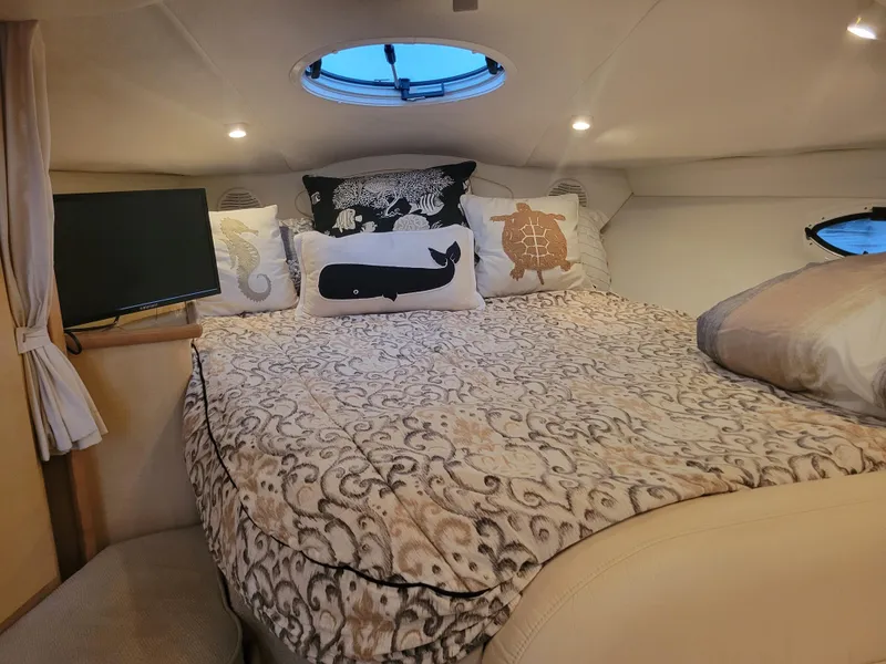 Slide: The Image of Cozy cabin interior of 2001 Maxum 3300 SCR with decorative pillows and bedding. - 9