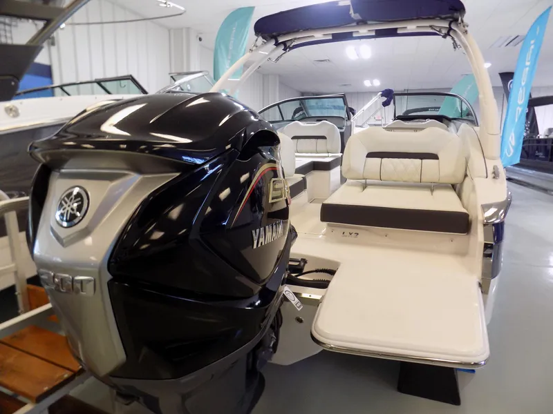 Slide: The Image of 2024 Regal LX2 boat with Yamaha engine, featuring spacious seating and modern design in showroom. - 11