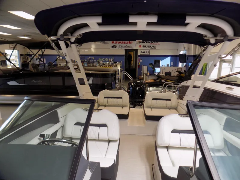 Slide: The Image of 2024 Regal LX2 boat interior with white seating in a showroom. - 4
