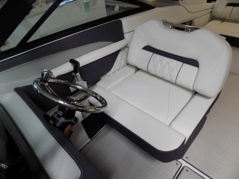 Slide: The Image of 2024 Regal LX2 boat interior with white leather seating and steering wheel. - 5