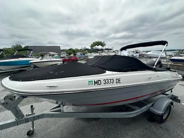 Slide: The Image of 2022 Bayliner VR4 Bowrider OB on trailer, covered and parked in a marina. - 10