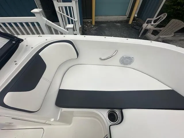 Slide: The Image of 2022 Bayliner VR4 Bowrider OB interior seating area with white and black upholstery. - 12