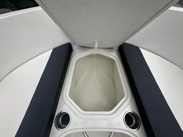 Slide: The Image of 2022 Bayliner VR4 Bowrider OB bow storage compartment with open lid and cup holders. - 15