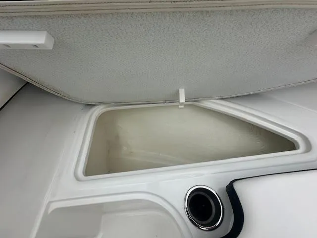 Slide: The Image of 2022 Bayliner VR4 Bowrider OB storage compartment with cup holder. - 16