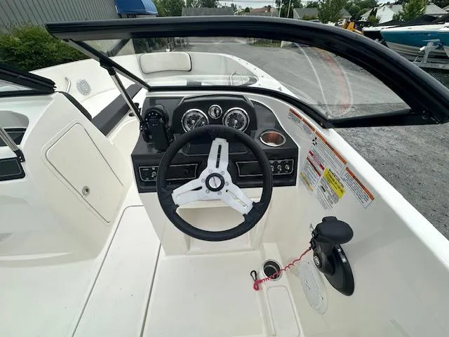 Slide: The Image of 2022 Bayliner VR4 Bowrider OB cockpit with steering wheel and control panel. - 21