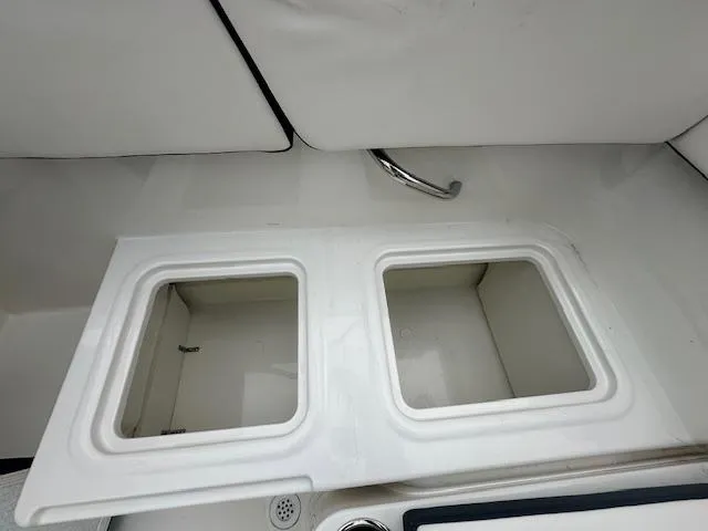 Slide: The Image of 2022 Bayliner VR4 Bowrider OB storage compartments with white interior. - 24