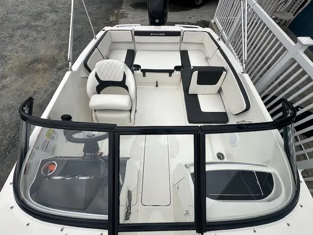 Slide: The Image of 2022 Bayliner VR4 Bowrider OB interior view, white and black seating, open bow design. - 28