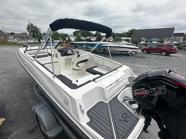 Slide: The Image of 2022 Bayliner VR4 Bowrider OB with Mercury Pro XS outboard motor in a parking lot. - 5