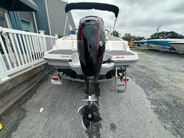 Slide: The Image of 2022 Bayliner VR4 Bowrider OB, rear view with outboard motor, parked on gravel. - 7