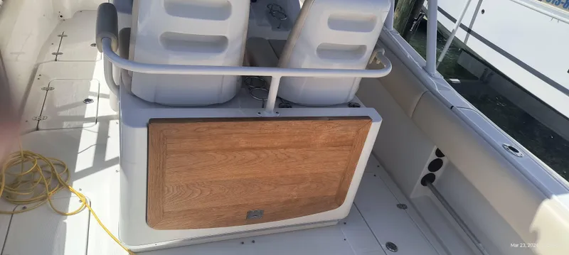 Slide: The Image of 2015 Chris-Craft Catalina 29 boat interior with seating and storage compartment. - 13