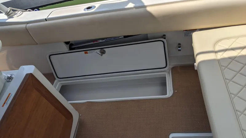 Slide: The Image of 2015 Chris-Craft Catalina 29 boat interior storage compartment and seating area. - 14