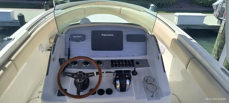 Slide: The Image of 2015 Chris-Craft Catalina 29 helm with Raymarine electronics and wooden steering wheel. - 16