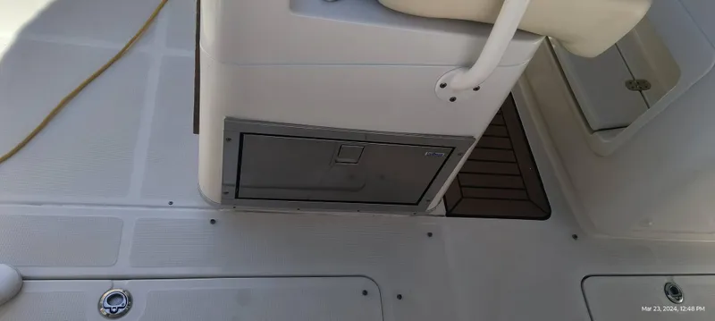 Slide: The Image of 2015 Chris-Craft Catalina 29 deck with storage compartment and seating. - 18