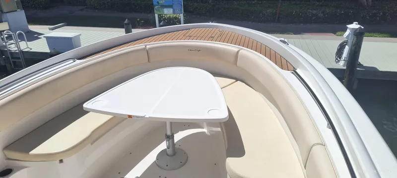 Slide: The Image of 2015 Chris-Craft Catalina 29 boat with cushioned seating and a center table. - 2